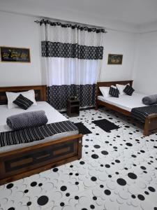 a bedroom with two beds and a carpet at The Off Road Homestay in Kandy