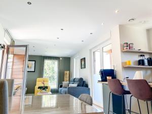 a living room with a table and chairs at Charmante maison à Évian avec terrasse et parking - FR-1-498-113 in Évian-les-Bains +4 photos