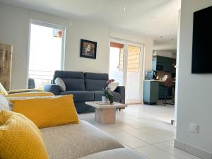 a living room with a couch and a table at Charmante maison à Évian avec terrasse et parking - FR-1-498-113 in Évian-les-Bains