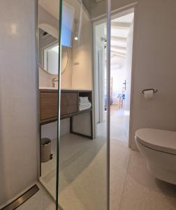 a bathroom with a sink and a toilet and a mirror at Apartments Ivas in Zambratija +55 photos