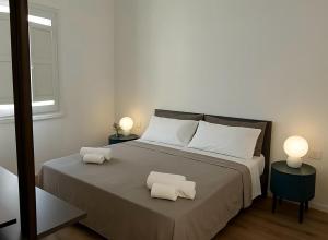 a bedroom with a large bed with two pillows on it at Blusanvito in San Vito lo Capo