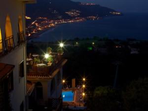 a view of a city at night with lights at Hotel Sirius in Taormina