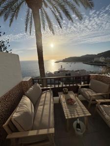 a patio with a couch and a table with a view of the ocean at Vistamar in Patalavaca
