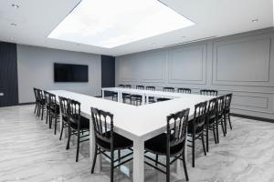 a conference room with a large white table and chairs at Golden Pars Hotel in Bursa