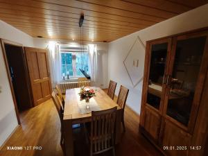 a dining room with a wooden table and chairs at Chalets in nature Nedderhagen in Damshagen +25 photos