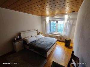 a small bedroom with a bed and a window at Chalets in nature Nedderhagen in Damshagen