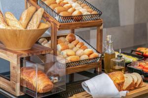 a display of bread and pastries on a table at INNSiDE by Meliá Düsseldorf Hafen in Düsseldorf