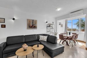 a living room with a black couch and a table at Apartment Lov&Mar with parking in Makarska