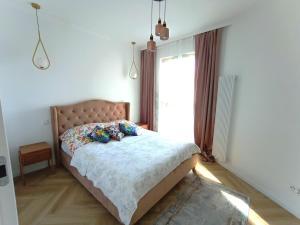 Posteľ alebo postele v izbe v ubytovaní Gdańsk Porto Apartments