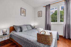 a bedroom with a bed with a basket on it at Apartment Lov&Mar with parking in Makarska
