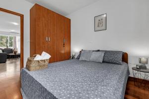 a bedroom with a bed and a wooden cabinet at Apartment Lov&Mar with parking in Makarska +4 photos