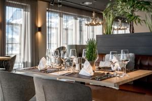 a long table with wine glasses and napkins on it at AlpenParks Hotel & Apartment Arlberg Warth mit Pool in Warth am Arlberg +47 photos