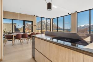 a kitchen with a view of the mountains at Seafront Luxury Villa near Henningsvær in Kleppstad
