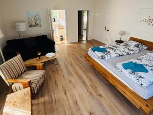 a living room with a large bed and a couch at Deichgräfin 1 in Horumersiel