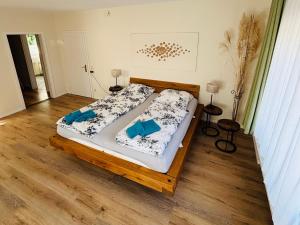 a bedroom with a bed with blue pillows on it at Deichgräfin 1 in Horumersiel