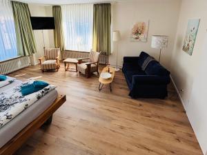 a living room with a bed and a couch at Deichgräfin 1 in Horumersiel