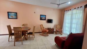 a living room with a dining room table and chairs at Sicarú Suites in Puerto Escondido