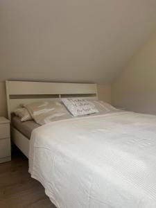 a bedroom with a large white bed in a room at Apartment Belaj in Celje