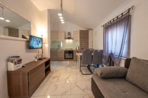 salon z kanapą i kuchnią w obiekcie Apartments LIMIA w Puli
