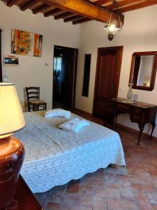 a bedroom with a bed and a table and a desk at Villa Nobile Cortona in Cortona