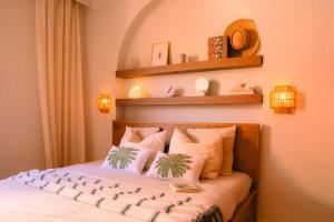 a bedroom with a bed with two plants on it at Casa Palmita Costa Calma in Costa Calma