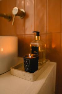 a bathroom counter with a soap dispenser and a candle at Casa Palmita Costa Calma in Costa Calma