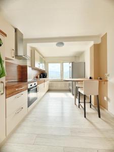 an empty kitchen with a table and a window at 95qm Komfort & Natur Pur in Werdohl