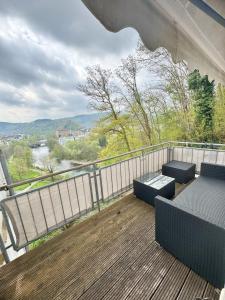 a balcony with benches and a view of a river at 95qm Komfort & Natur Pur in Werdohl
