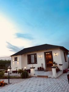 a white house with a door and a patio at Dhawanfarms in Bela +5 photos