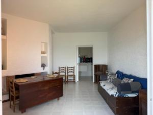 a living room with a couch and a table at Vista Mare in Porto Santo Stefano +12 photos