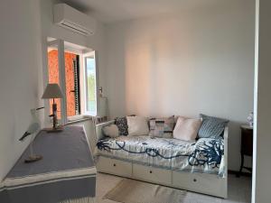 a living room with a couch and a window at Vista Mare in Porto Santo Stefano