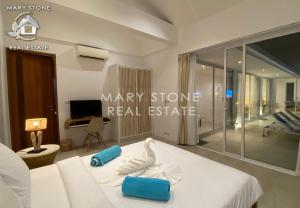 a bedroom with a white bed with a swan on it at Villa V4 IDYLLIC - Stunning Seaview in Ban Bang Po +69 photos