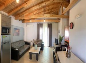 a living room with a couch and a table at Villa Orestis - Stoupa Seaside Retreats in Stoupa