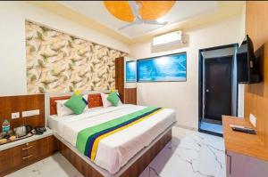 a bedroom with a large bed in a room at Agy Hotels in Pune