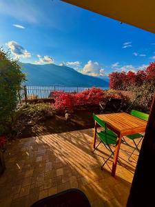 a table and a chair on a patio with a view of the ocean at residenza gelsomino - relax and view in Bellano