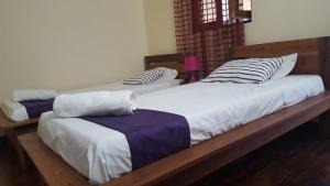 two twin beds sitting next to each other in a room at Ankaratra Résidence Hôtel in Mandriankeniheny