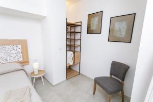a bedroom with a bed and a chair and a table at Lo Scirocco in Nardò