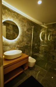a bathroom with a sink and a glass shower at Cesme Villa Mona Ovacık luxury villa in Cesme