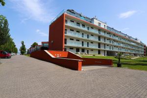 a large building with a ramp in front of it at BL lakeview Apartman in Balatonlelle +14 photos