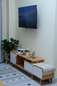 a living room with a tv hanging on a wall at The Nordic Nest in Ruiru