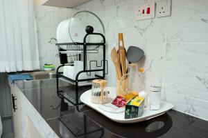 a kitchen counter with utensils on a shelf at The Nordic Nest in Ruiru +4 photos