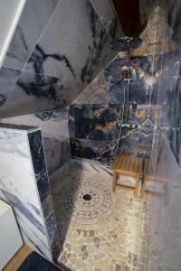a bathroom with a shower with a bench in it at B&B LA FESSARDIERE Piscine - Jacuzzi in Saint-Maurice-sur-Fessard +23 photos