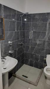 a bathroom with a toilet and a sink at Vila F&L in Vlorë +13 photos