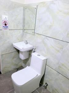 a bathroom with a toilet and a sink at Thamarassery INN luxury and Budget Rooms in Thamarassery