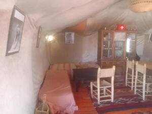 a room with a bed and a desk in a tent at Sahara family camp in Merzouga