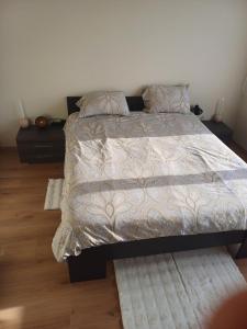 a bedroom with a large bed with rugs at Cosy -confort appartment in Antwerp