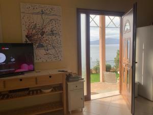 Televízia a/alebo spoločenská miestnosť v ubytovaní Amfiteatrico Sea View - Kalamos Attiki