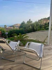 two lawn chairs sitting on a deck with a view at La casa dell'orto in Imperia