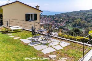 a house with a balcony with a view of the city at Suite Ulivo by Villa Melograno, Pool, AC, Parking in Santa Margherita Ligure