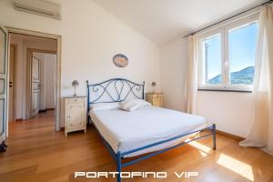 a bedroom with a bed and two windows at Suite Ulivo by Villa Melograno, Pool, AC, Parking in Santa Margherita Ligure